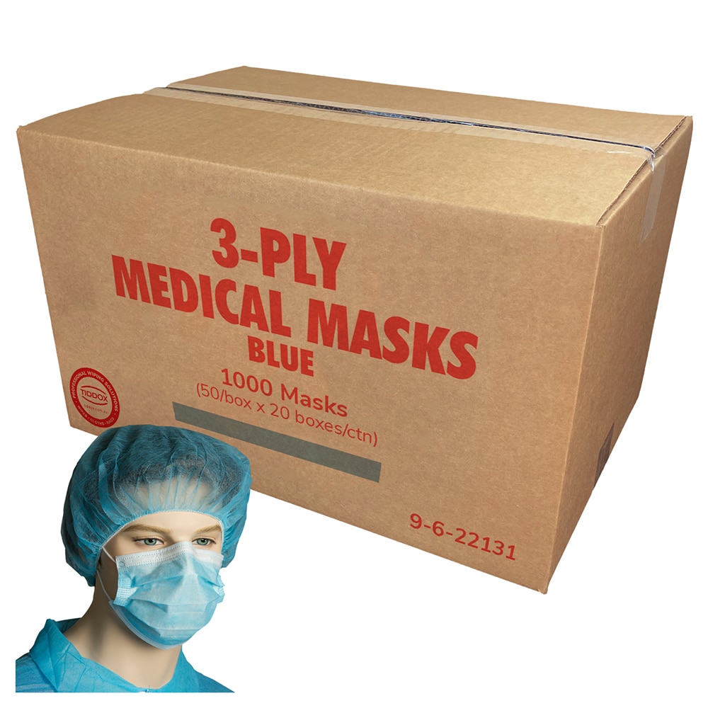 A mannequin head wearing blue medical face masks with a cardboard box in the background with large red writing