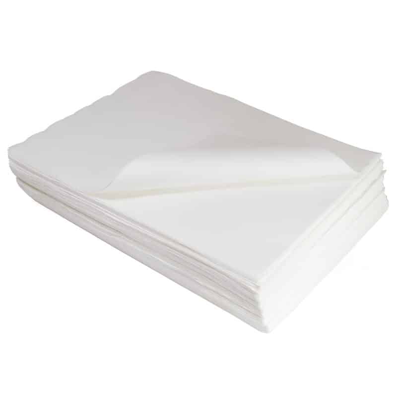 Well-arranged stack of white strong wipes with the top wipe gracefully curved at an angle against a plain background.