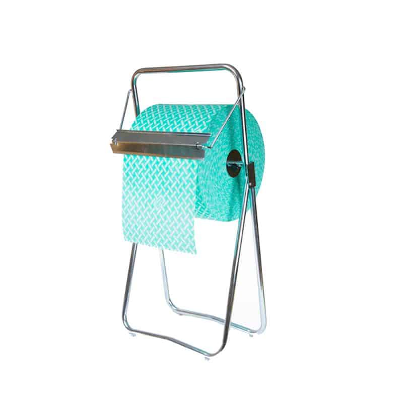 A jumbo green roll sits in a metal floor dispenser against a white background.