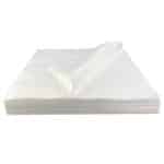 Side view of a white LintNIL wipe stack with the top wipe folded over to the left
