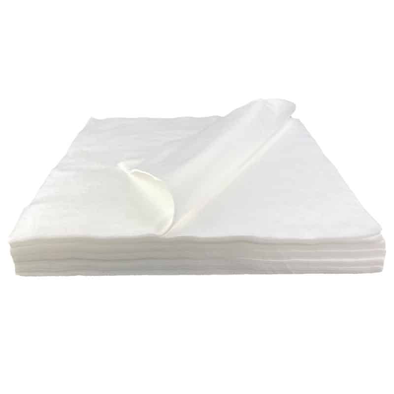 Side view of a white LintNIL wipe stack with the top wipe folded over to the left