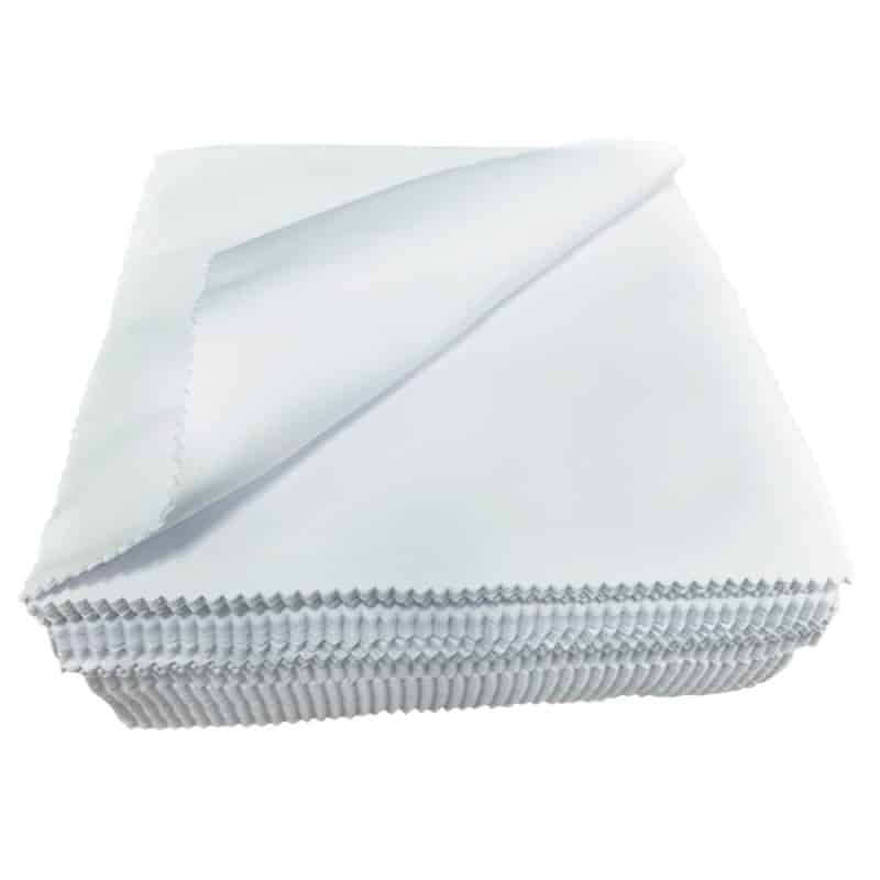 Stack of white Lens cloths with the top cloth curved to the top left corner