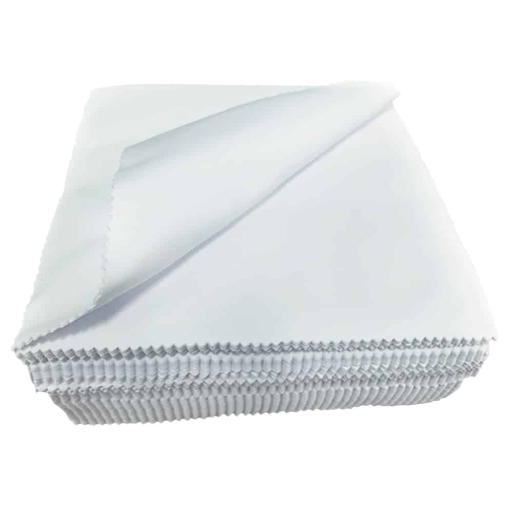 Stack of white Lens cloths with the top cloth curved to the top left corner