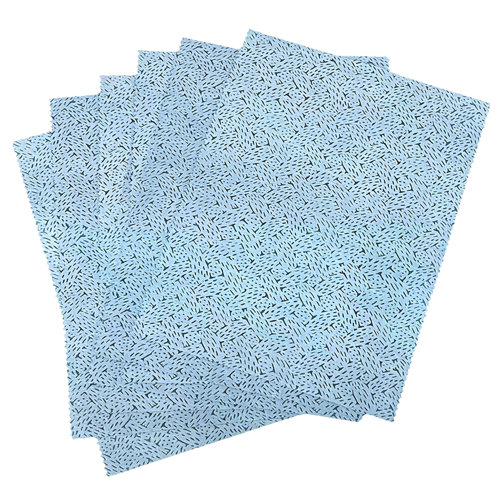 Textured blue oil absorbing wipes with a pattern fanned out on a plain background