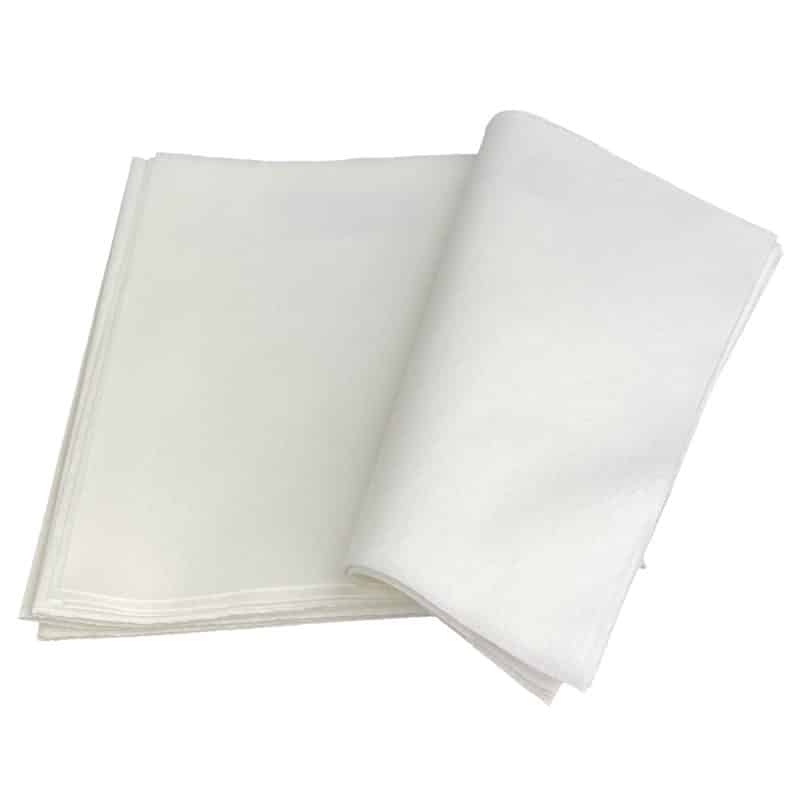 a stack white tray liners with the top layer curved open to the right
