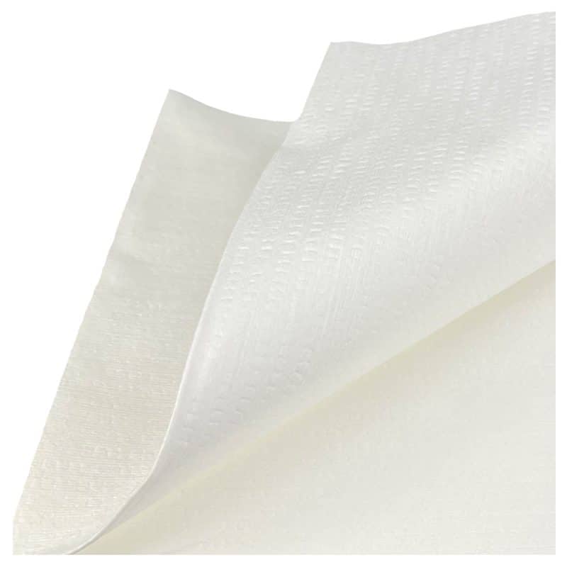 Close-up of a stack of white wipes, focusing on the top wipe with a curved appearance.